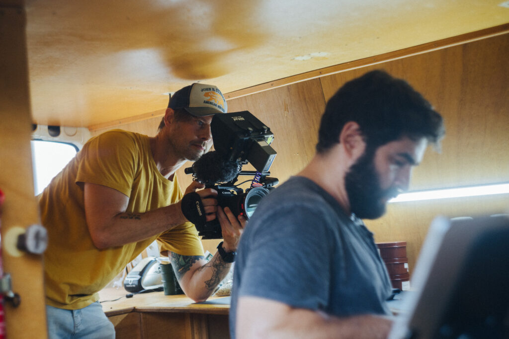 Robin Danehav filming coffee expert Rafa, a bearded man, inside the mobile cupping van in Brazil.