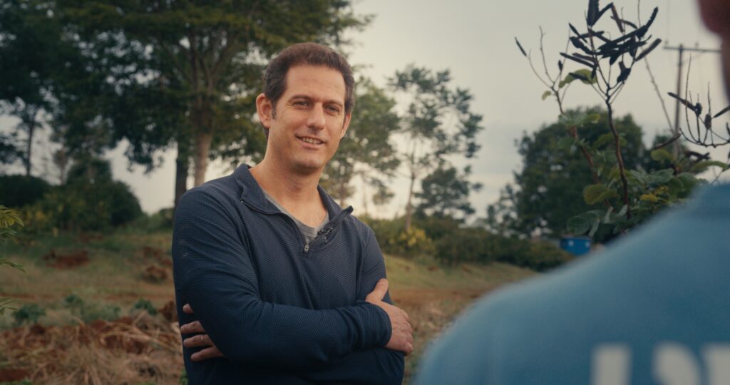 Felipe Croce standing outdoors with his arms crossed, trees behind him.